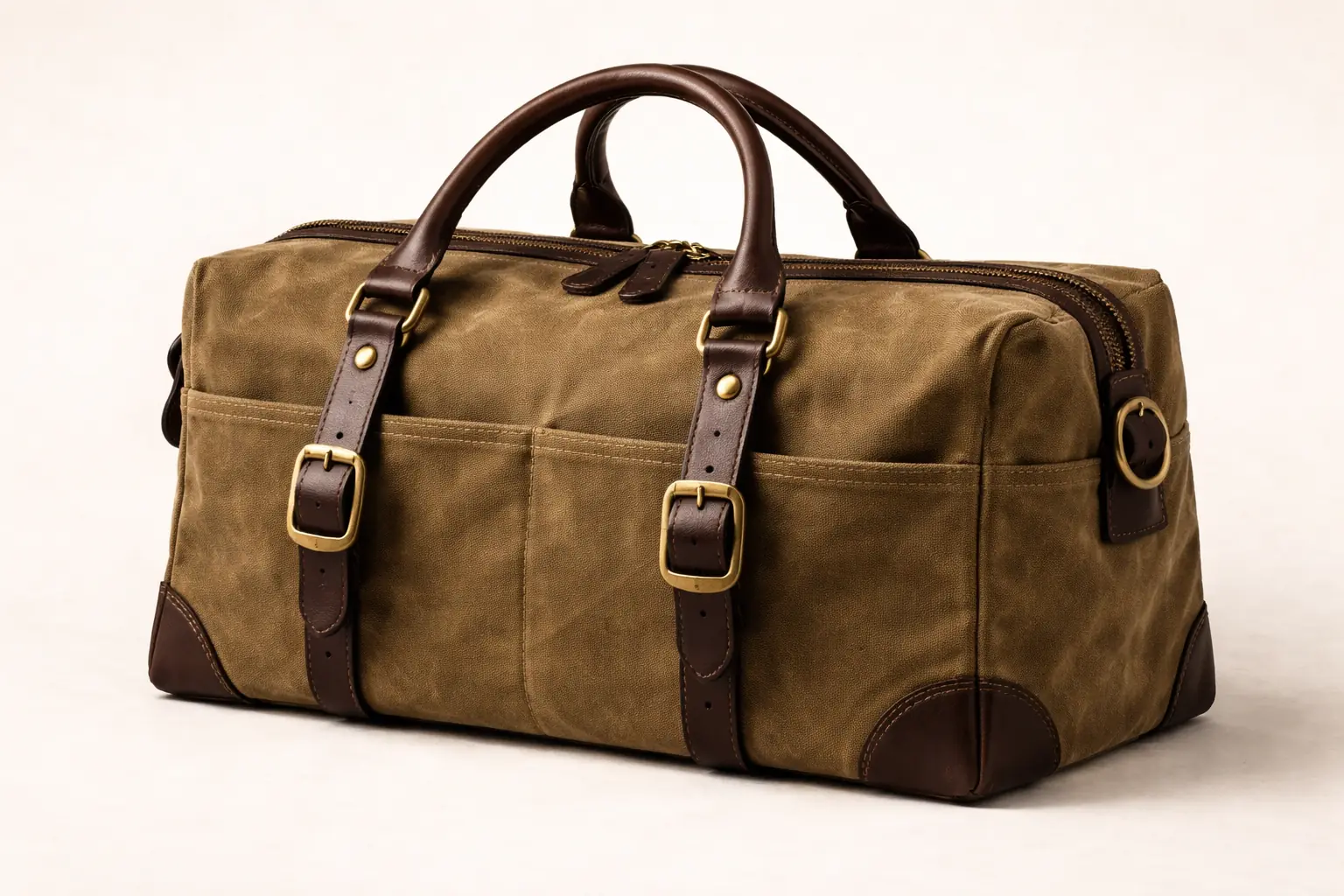 Waxed canvas tool bag — brass hardware, leather handles, newspaper-lining print